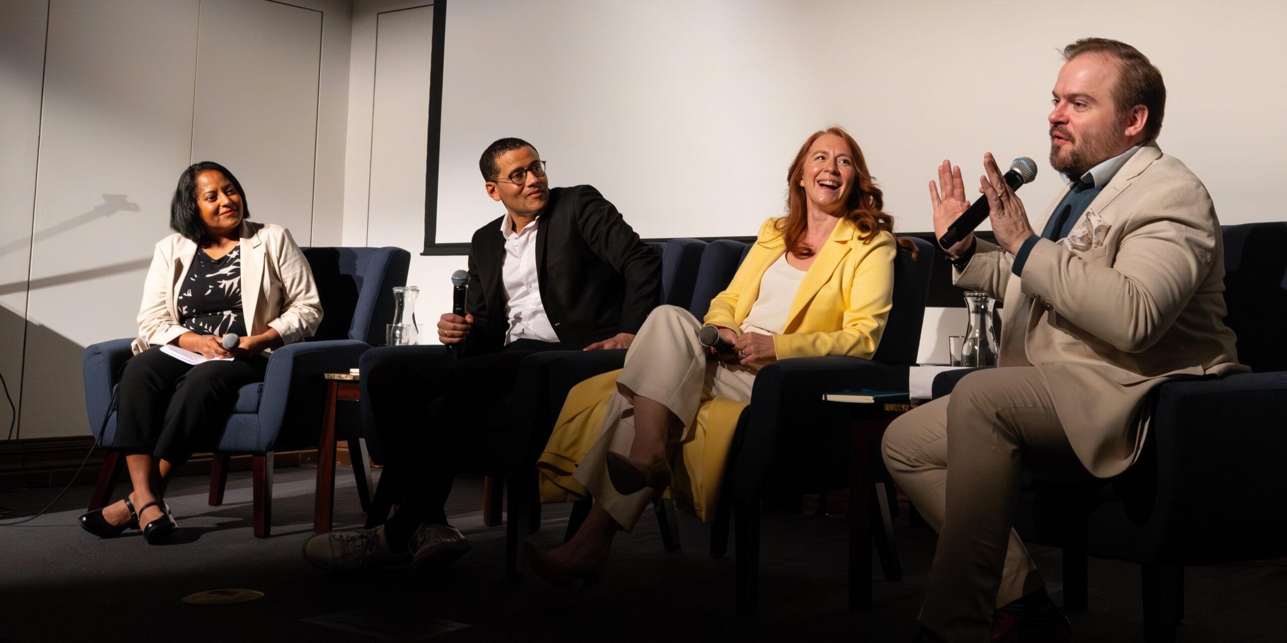 Panel discussion at the National Liberty Museum featuring four speakers seated onstage with microphones, engaging in conversation similar to what will be featured in the NEH grant-funded podcast series.